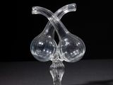 two clear glass vases sitting on top of a black table