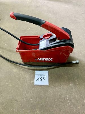 a red box with a black handle on the floor