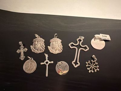 a lot of silver charms that are on a table