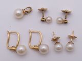 four pairs of pearl earrings and a pair of gold - plated earrings