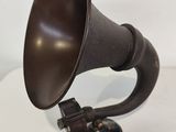 a close up of an old fashioned gramphone on a white surface