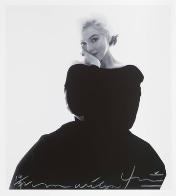a black and white photo of a woman in a dress