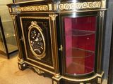 a black and gold cabinet with a clock on top of it