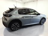 the rear end of a silver car in a white room