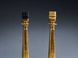 a pair of brass table lamps with black lampshads