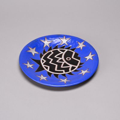 a picture of a blue plate with a black and white design on it