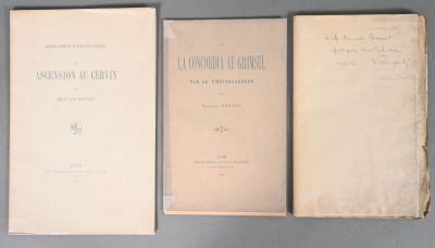three old books sitting on top of a table next to each other
