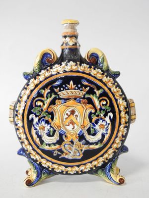 a blue and yellow vase on a stand on a white surface