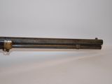 a close up of a gun on a table with a white background