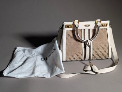 a white purse and a cloth bag on a table