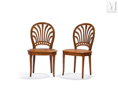 two wooden chairs sitting next to each other on top of a white surface