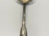 silver plated spoon on a white surface with a spoon in the middle of the spoon