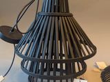 a lamp that is sitting on a table next to a cup