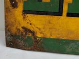 a yellow and green sign on a white table