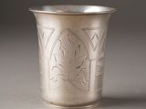 a silver cup that has a design on it