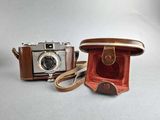 a brown camera and a brown case on a white background