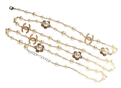 a close up of a necklace with pearls on a white background