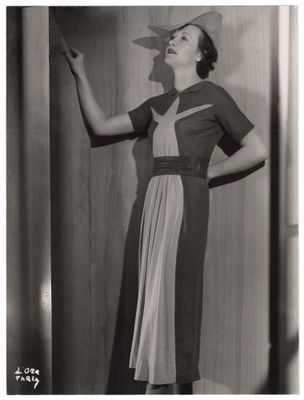 photographie en noir et blanc d'une femme en robe et chapeau