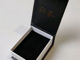 a black and white box with a watch inside of it
