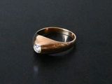 a close up of a ring with a diamond on it