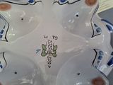 a white plate with blue and brown designs on it