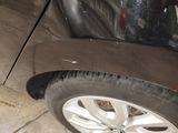 a close up of a car ' s tire on the ground