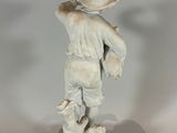 a statue of a boy with a hat and a dog