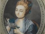 portrait of a woman holding a bird in her hands