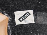 a sticker on the back of a skateboard that is on the ground