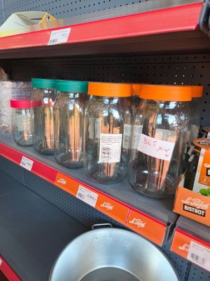 many jars and pans on the shelves in the store