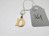 un gros plan d'une étiquette sur laquelle figure un petit « d » doré