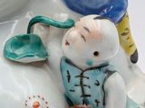 two figurines of a boy and a girl sitting on a polar bear