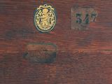 a wooden box with a gold emblem on it
