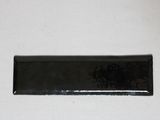 a black rectangular plate on a white table