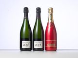 three bottles of champagne are lined up on a table