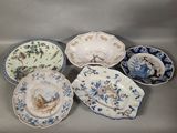 six plates with blue and white designs on them sitting on a table