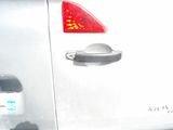 a close up of a silver car with a red light on it