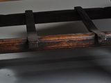 a wooden bench with a leather strap on it