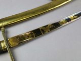 a gold and black sword on display on a table