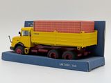 a yellow and red truck on a blue box