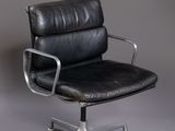 an image of a black leather office chair against a gray background