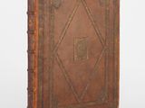 an old book with a brown cover on a white background
