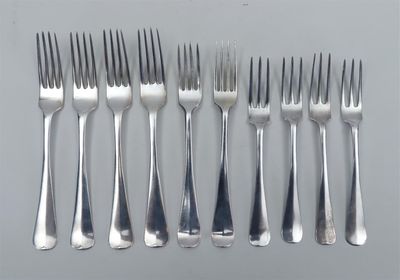 six fourchettes et un couteau sur une table