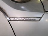 a close up of a car ' s emblem on the side of the car