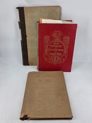 two old books sitting on top of a table next to each other