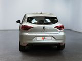 the rear end of a silver car parked in a white room