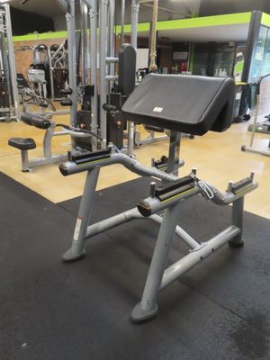 a gym room with machines and weights on the floor