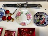 a table with a knife, plate, spoon, and other items on it