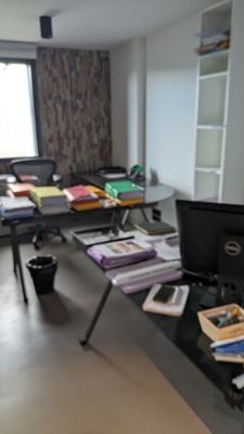 a desk with a computer and a lot of books on it