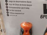 two orange and black screwdrivers on display in a store